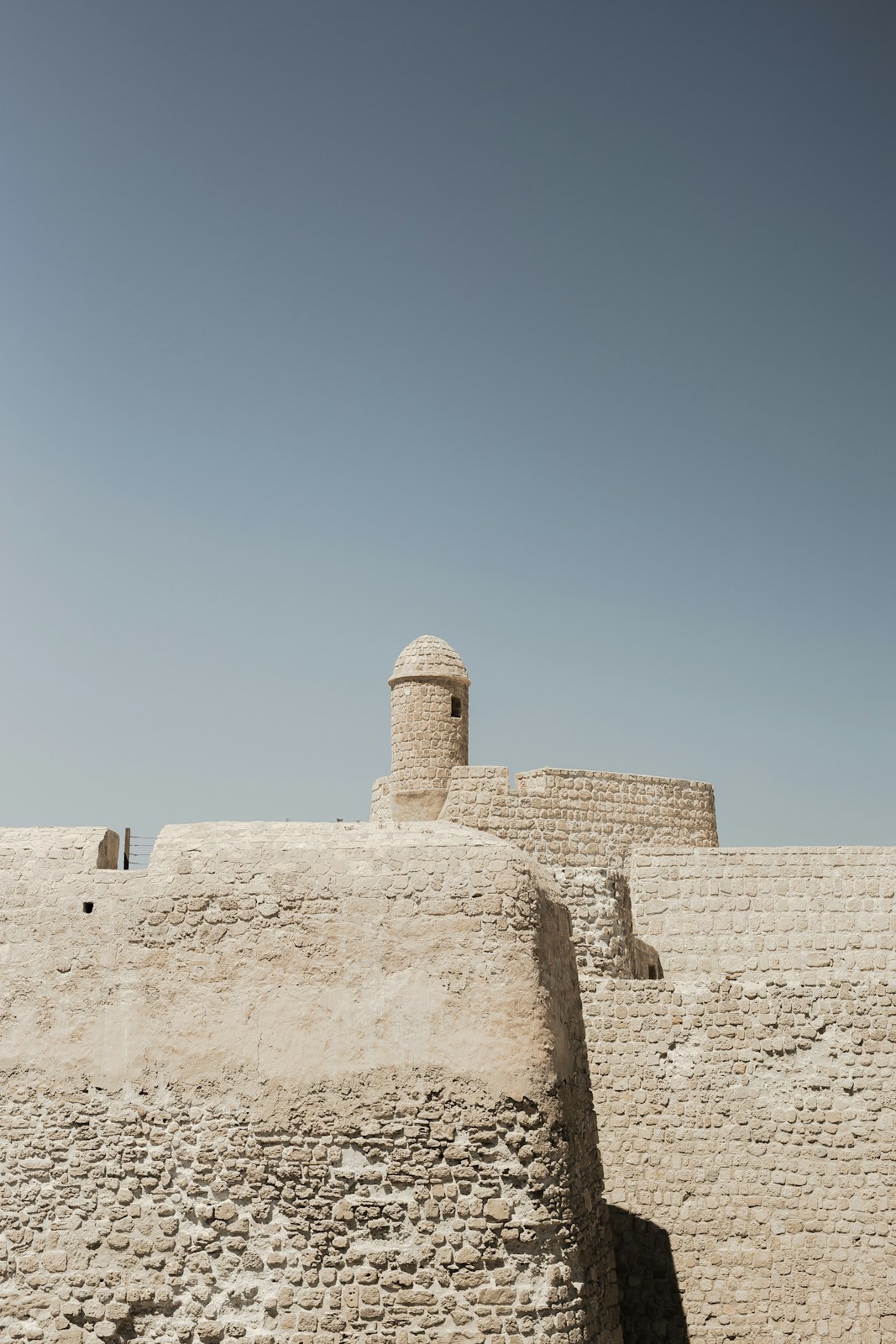 A stone building with a clock tower on top of it