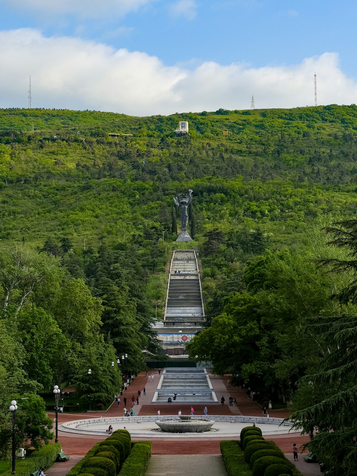 Monumental statue atop a long staircase on a hill