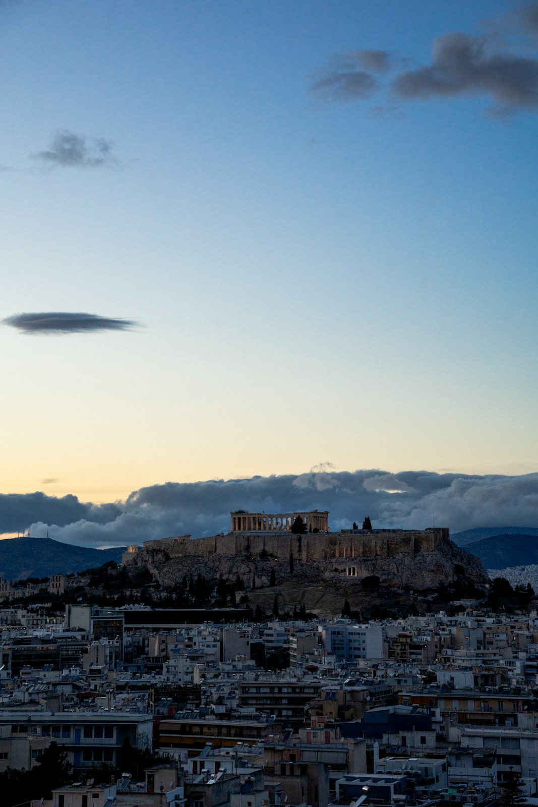 The acropolis of athens at dusk with clouds