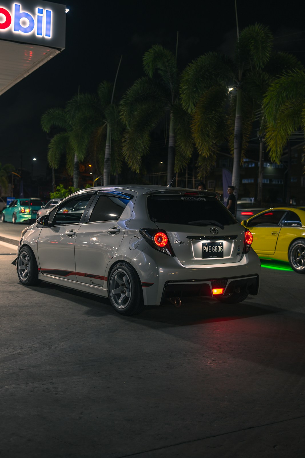 A modified white car at night
