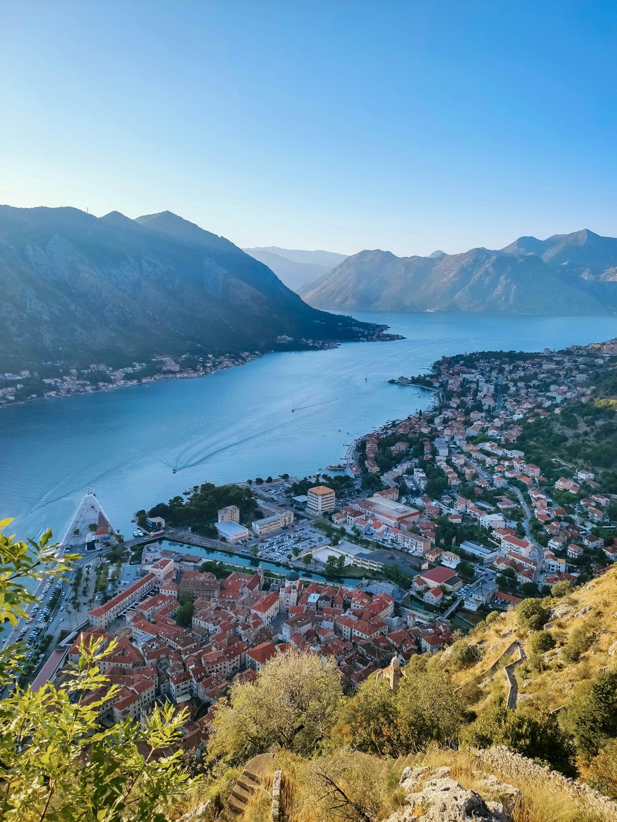 a scenic view of a town and a body of water