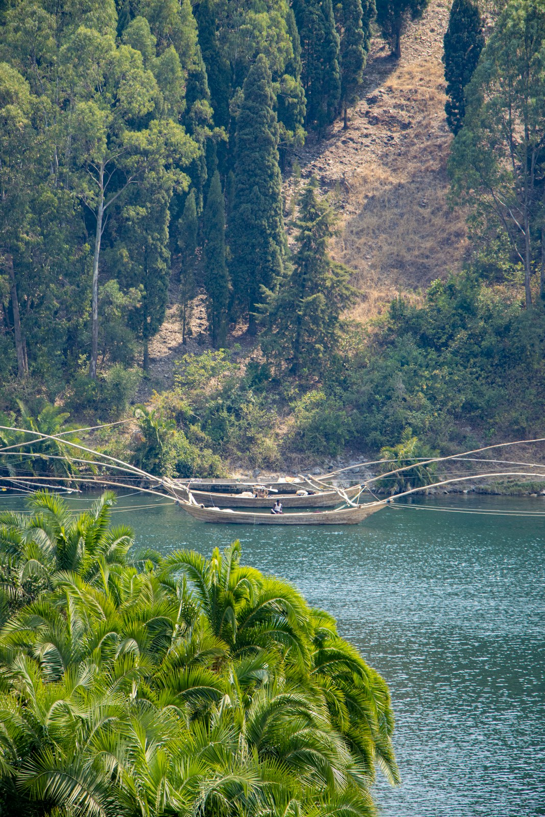 Boat with fishing nets on a calm lake