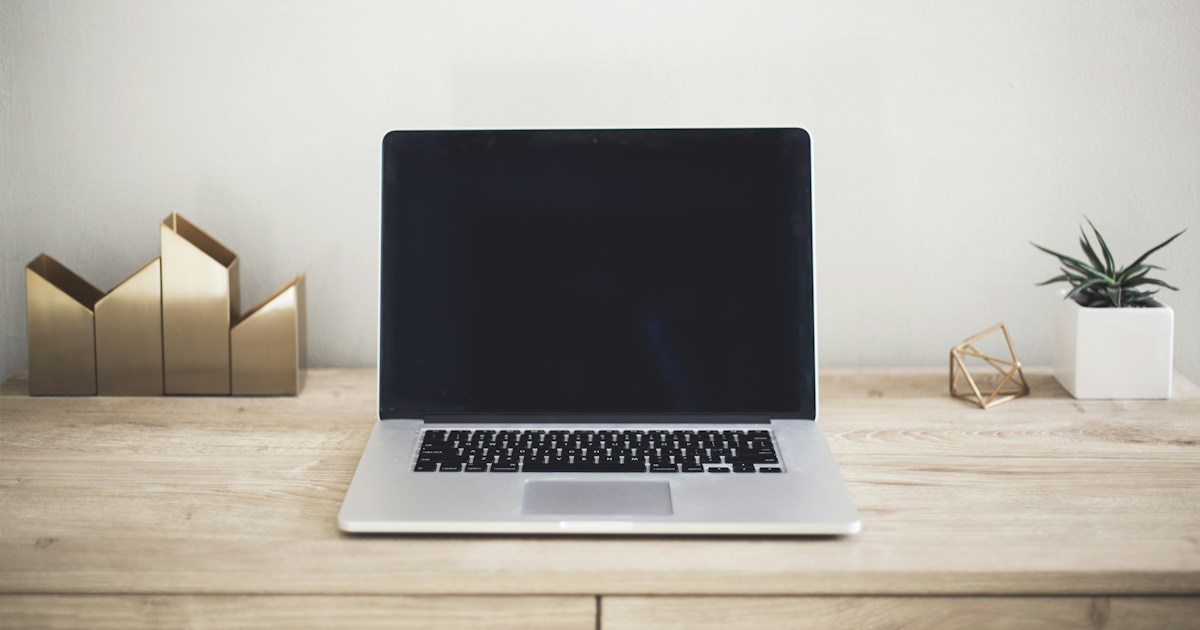 MacBook Pro on top of brown table